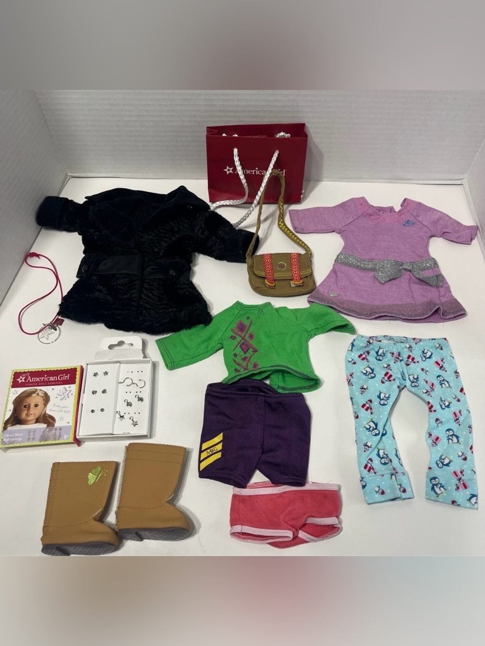 AMERICAN GIRL 18” doll lot of doll clothes and doll earrings.